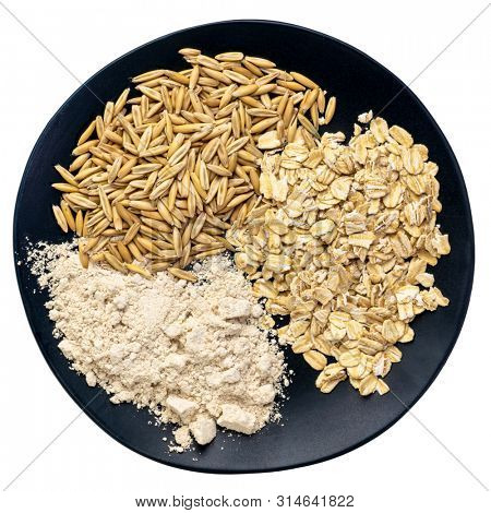gluten free whole, organic oat groats, flakes and flour  - top view of an isolated black plate