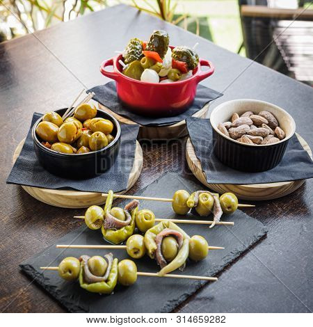Different Types Of Spanish Tapas, Banderillas, Gildas, Olives And Almonds