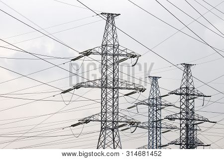 High Voltage Towers With Electrical Wires On Cloudy Sky Background. Electricity Transmission Lines, 