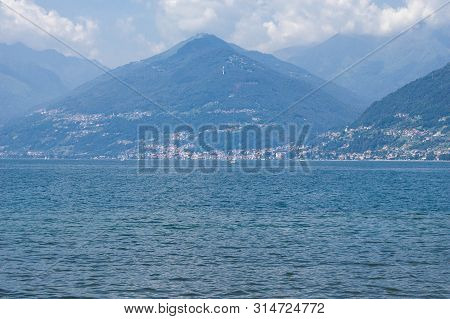 View Of Mountain Lake On A Sunny Summer Day. District Of Como Lake, Colico, Italy, Europe