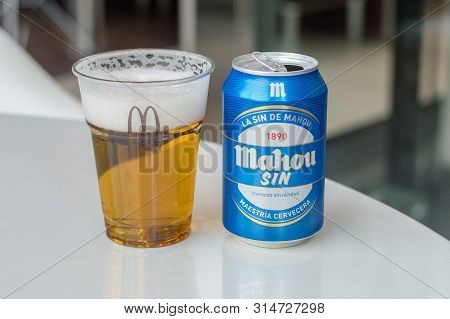 Andorra, Andorra - June 3, 2019: Mahou Beer In A Plastic Cup With Mcdonald Logo And Can Of Mahou Sin
