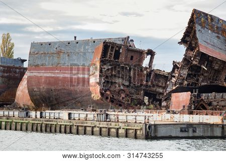 Huge Rusty Pieces Of Decommissioned Marine Ship That Was Cut And Left On The Shore.