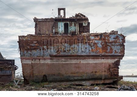 Huge Rusty Pieces Of Decommissioned Marine Ship That Was Cut And Left On The Shore.