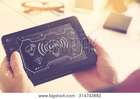 Lifi Theme With Man Holding A Tablet Computer