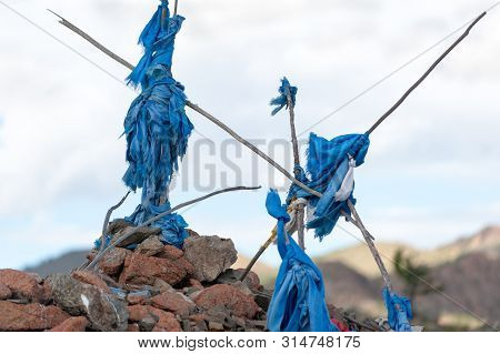 Ribbons Of Blue Or White Fabric On Top Of The Man-made Stone Obelisk Obo On A Mountain Pass In Mongo