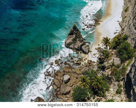 Aerial Drone Photo Of Tropical Beach, Sea Rocks, Turquoise Ocean And Palm Trees. Atuh Beach, Nusa Pe