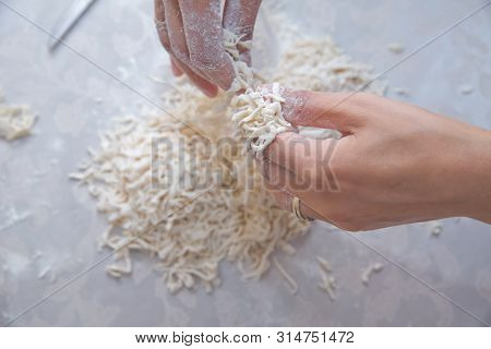 Cutting Long Dough Stripe For Cooking Pasta. Homemade Food Preparation Concept. Closeup Of Process O