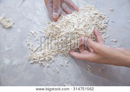 Cutting Long Dough Stripe For Cooking Pasta. Homemade Food Preparation Concept. Closeup Of Process O
