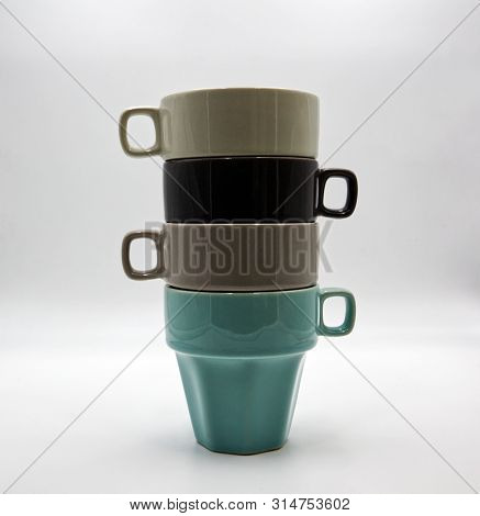 Pile Of Colored Mugs Isolated On White Background