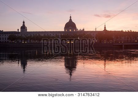 Hotel Dieu In Lyon, France, Taken From The Rhone Riverbank During An Evening Sunset. Hotel Dieu Is A