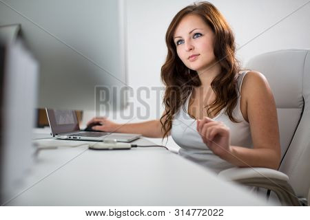 Woman working on a computer in a home office