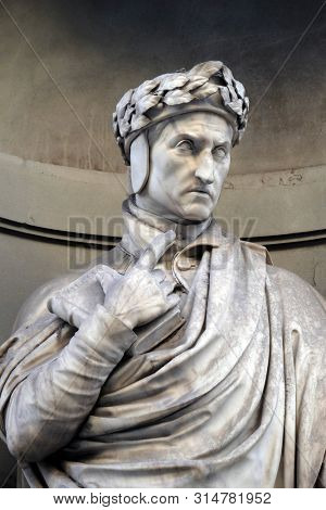 FLORENCE, ITALY - JANUARY 11, 2019: Dante Alighieri statue in the Niches of the Uffizi Colonnade in Florence, Italy