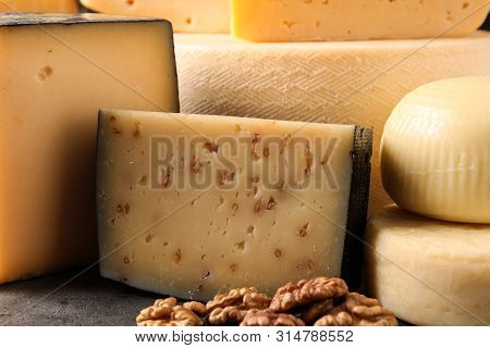 Different Types Of Delicious Cheese On Table, Closeup