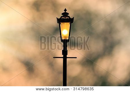 A Classic Style Of Lantern With Sunset Background (sillhouette)