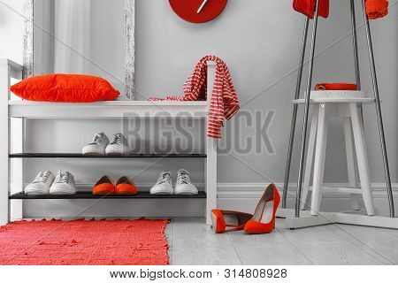 Stylish Hallway Interior With Shoe Rack And Rug