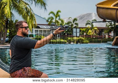 Bearded Man Launches Drone For Flight, With Which You Can Take Photos And Video Filming, Near The Sw