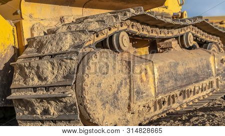 Panorama Yellow Excavator With Close Up View Of The Grouser Pad Track Frame And Rollers