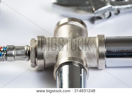 Water Braided Metal Hose With Connecting Internal Screw. Close Up Flexible Hydraulic System. Plumbin
