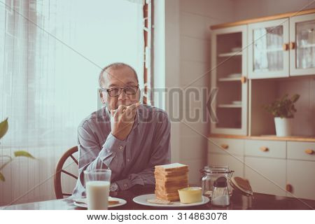 Asian Elderly Male Eathing Bread Healthy Food For Breakfast,retirement Senior Lifestyle Living Conce