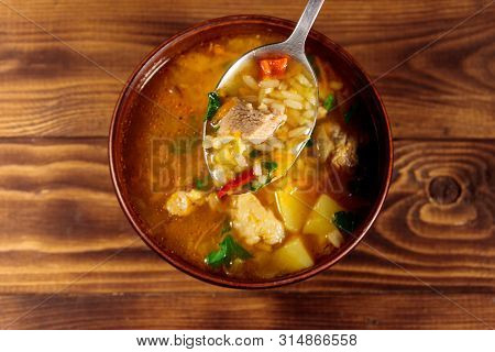 Kharcho Soup With Meat And Rice On Wooden Table. Top View