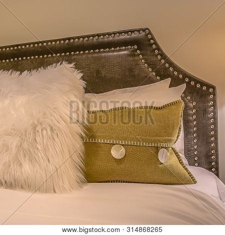 Square Frame Bedroom Interior With Pillows Against Upholstered Belgrave Headboard Of A Bed