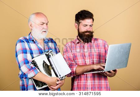 Renovation. Two Bearded Men. Vintage Typewriter. Youth Vs Old Age. Business Approach. Technology Bat