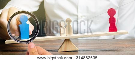 Wooden Figures Of People On Scales. The Court Decision On Custody Of The Children By One Of The Pare