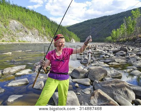 Happy Young Fisherwoman Caught A Big Fish - Lenok. Trophy Catch. Good Fishing.