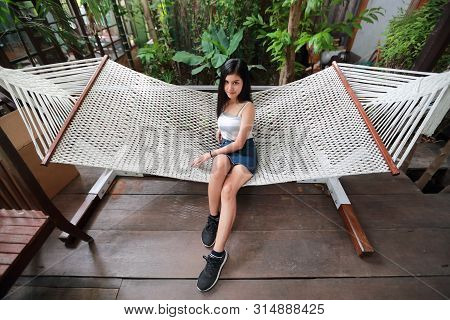 Portrait Of Beautiful And Cute Asian Woman Lying In A Hammock