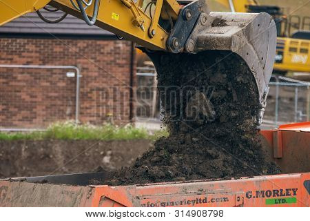 Sheffield, Uk - 1st August 2019: A Digger And Dump Truck Move Dirt To Make Room For The Foundations 
