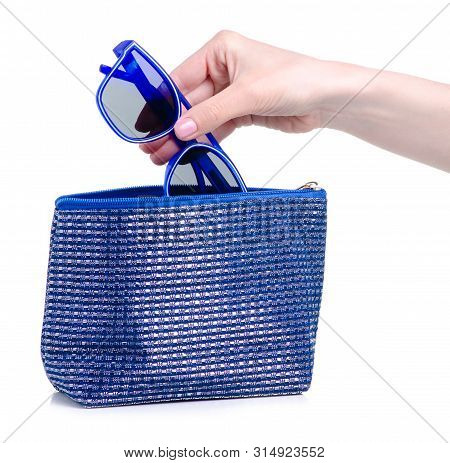 Blue Sunglasses Put In Blue Cosmetic Bagon A White Background. Isolation