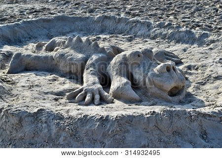 Concept Crocodile, Alligator Made Of Sand On The Beach