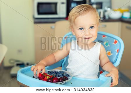 Adorable Cute Caucasian Blond Toddler Boy Enjoy Tasting Different Seasonal Fresh Ripe Organic Berrie
