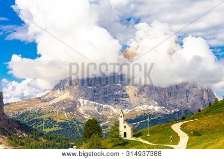 San Maurizio Chapel On The Passo Di Val Gardena With Mountain View In Background. Colorful View In P