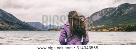 Nature travel panoramic banner woman hiker adventure wanderlust in Yukon travel tourist walking on beach in Carcross, Canada.