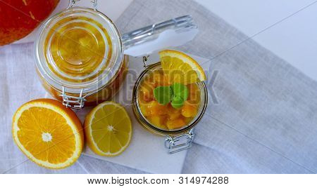 Pumpkin Jam Or Marmalade With Orange And Lemon. In The Background Is A Pumpkin. Two Glass Jars Of Pu