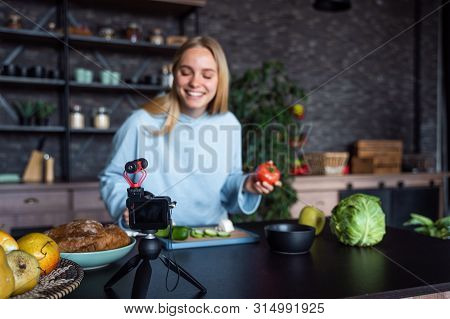 Young Beautiful Blonde Takes On Videos As She Cooks In The Kitchen