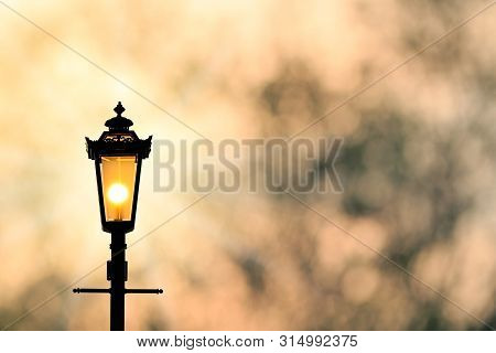A Classic Style Of Lantern With Sunset Background (sillhouette)