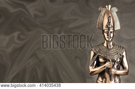 Statuette Of The Egyptian Pharaoh Tutankhamun On A Brown Background.