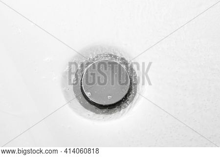 bathtub drain, close-up view, white background