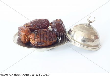 Dried Palm Date Fruits In A Silver Bowl On White Background.