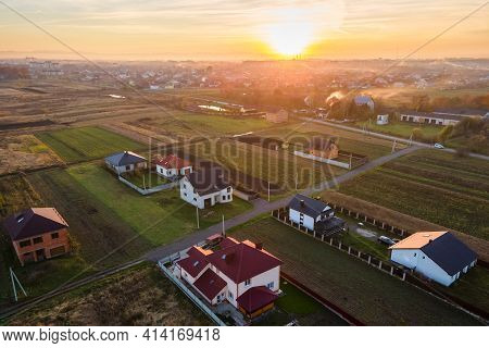 Aerial View Of Private Homes In Rural Suburban Area At Sunset.