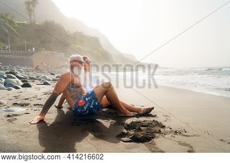 Lifestyle Caucasian Senior Couple Sitting On The Beach, Happy In Love Romantic And Relax Time, Touri