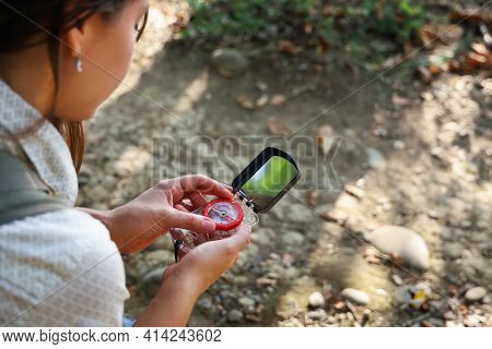 Selective Focus On Compass In Hands Of Tourist Woman To Specify Direction Of Further Movement In Azi