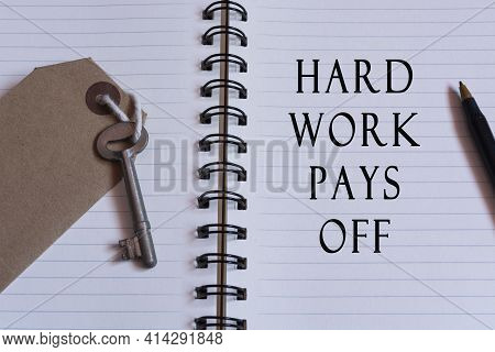 Text Written On Notebook With House Key - Hard Work Pays Off