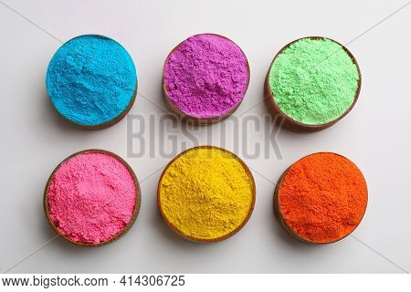 Colorful Powders In Bowls On Light Background, Flat Lay. Holi Festival Celebration