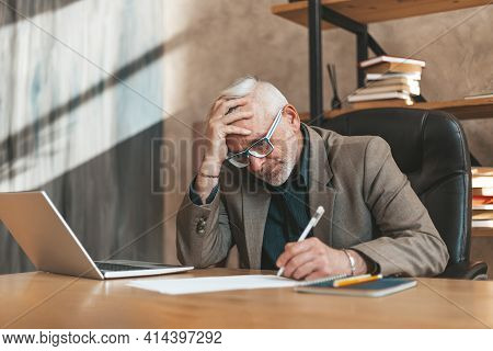 Sign A Will. The Senior Man Clings To His Head In Despair And Signs The Document. Financial Problems