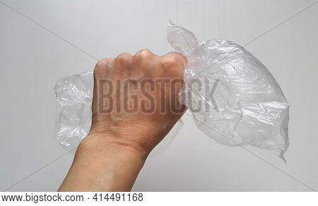 Hand Holding A Plastic Pack, Close-up. For A Clean Planet Without Plastic. Separate Garbage Collecti