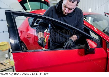 Car Service Worker Cleans Interiror With Special Brush