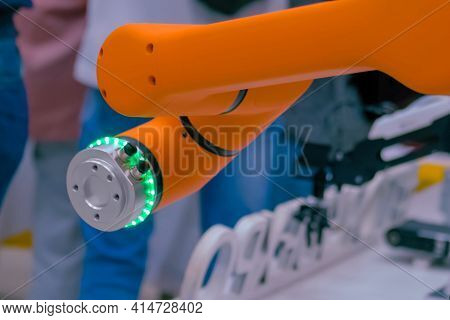 Orange Collaborative Robot, Cobot Hand Moving At Exhibition, Trade Show - Close Up View. Science, Fu